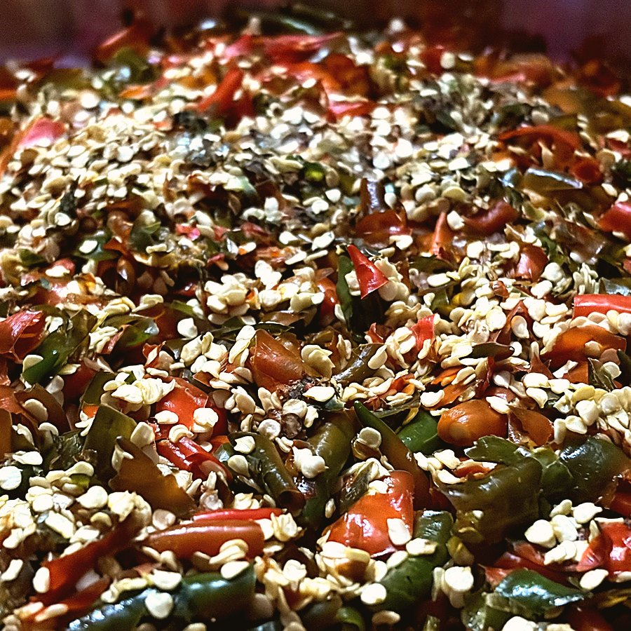 Red and green chillies chopped in a steel pan